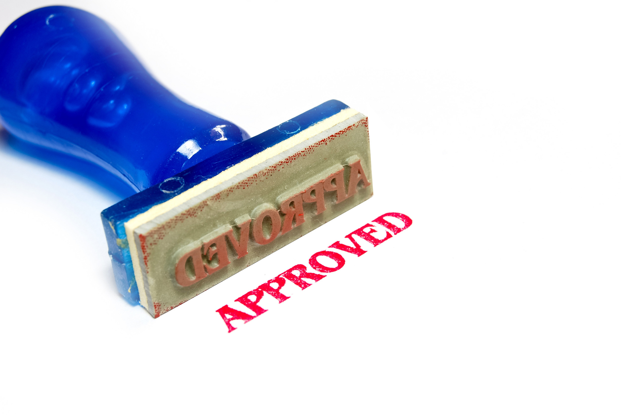 approved letter on blue rubber stamp