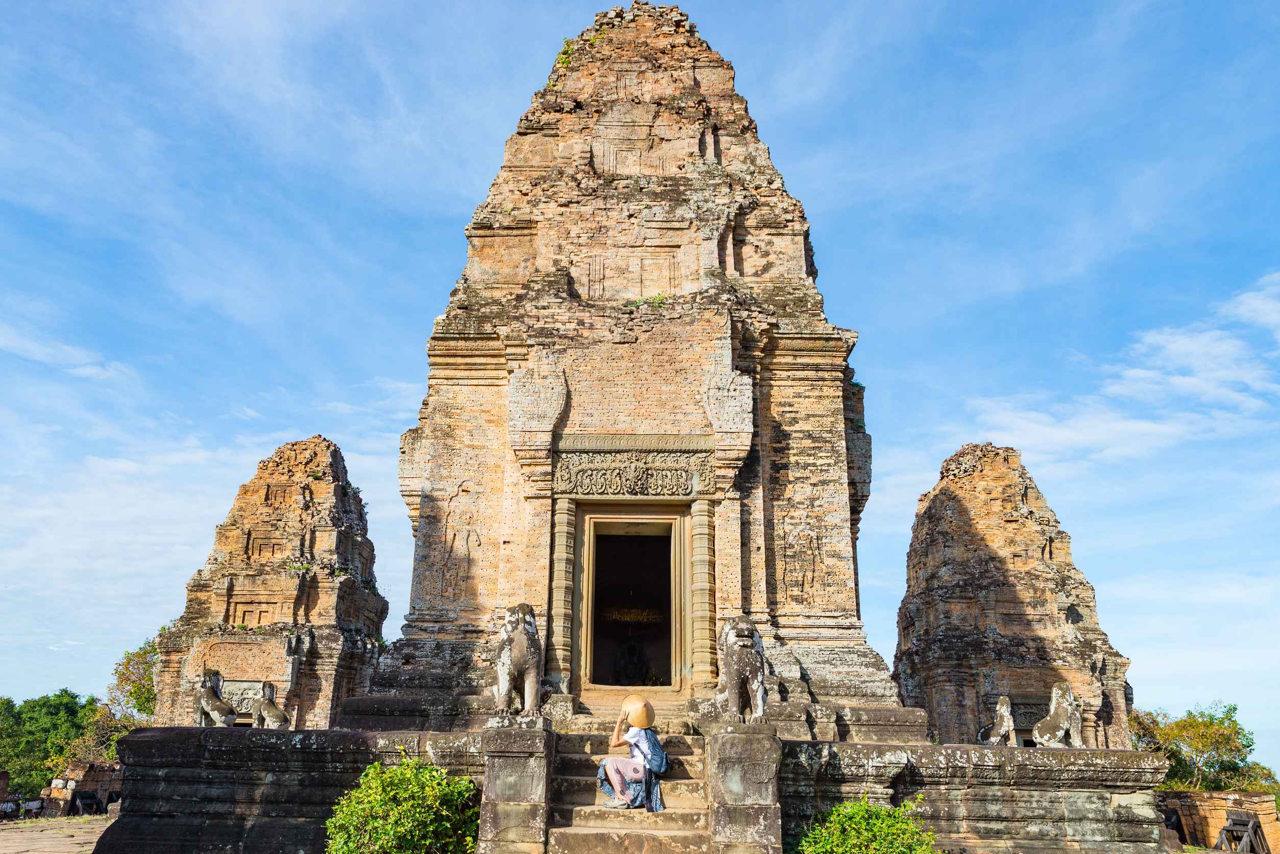 one tourist visiting Angkor ruins amid jungle