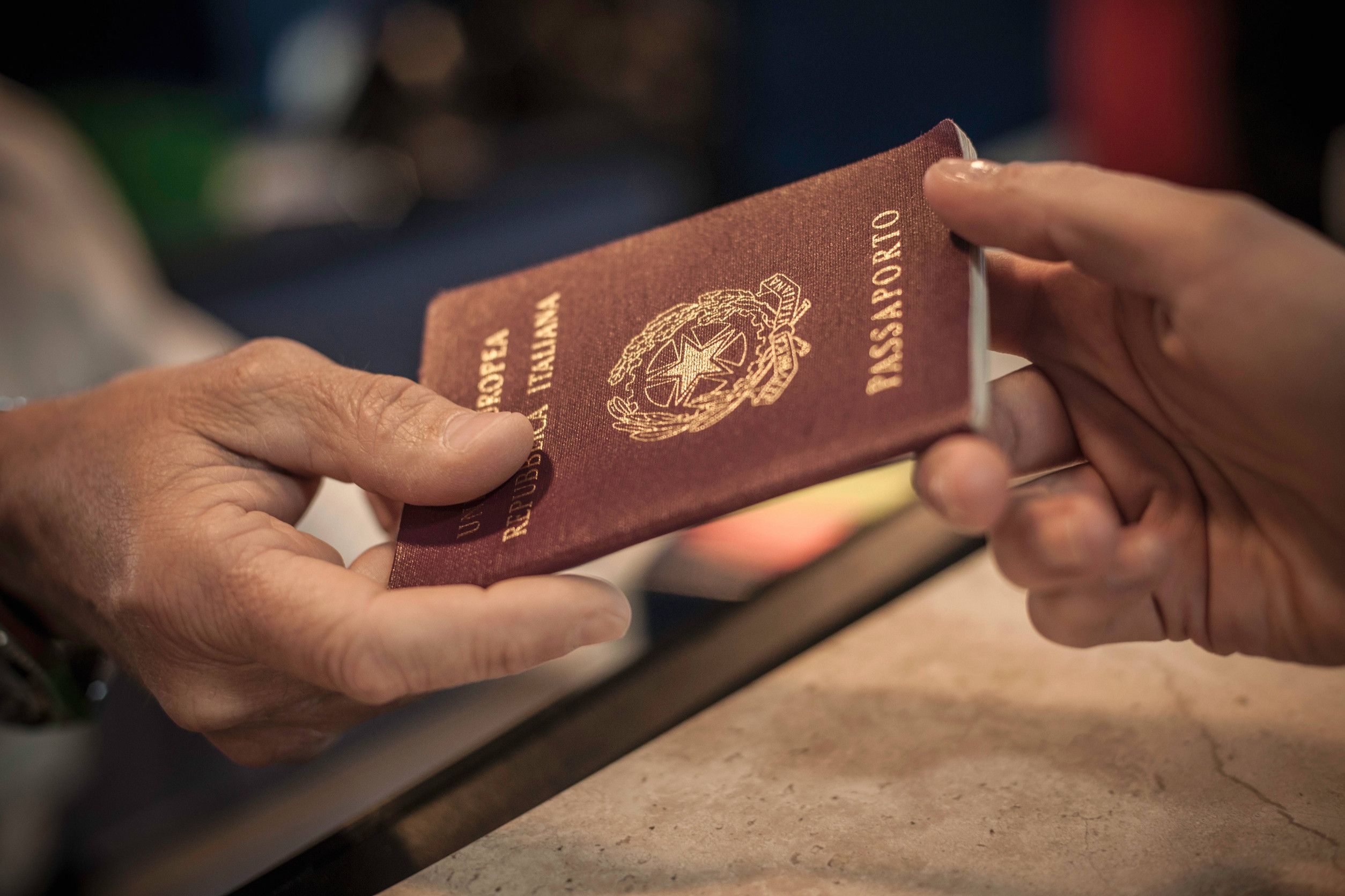 person handing over passport close up