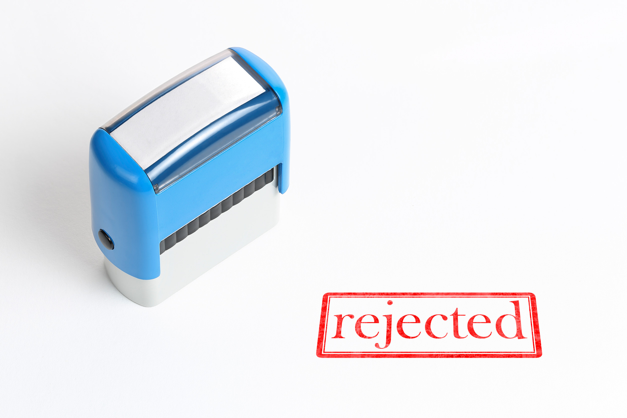 Rejected stamp on white paper surface