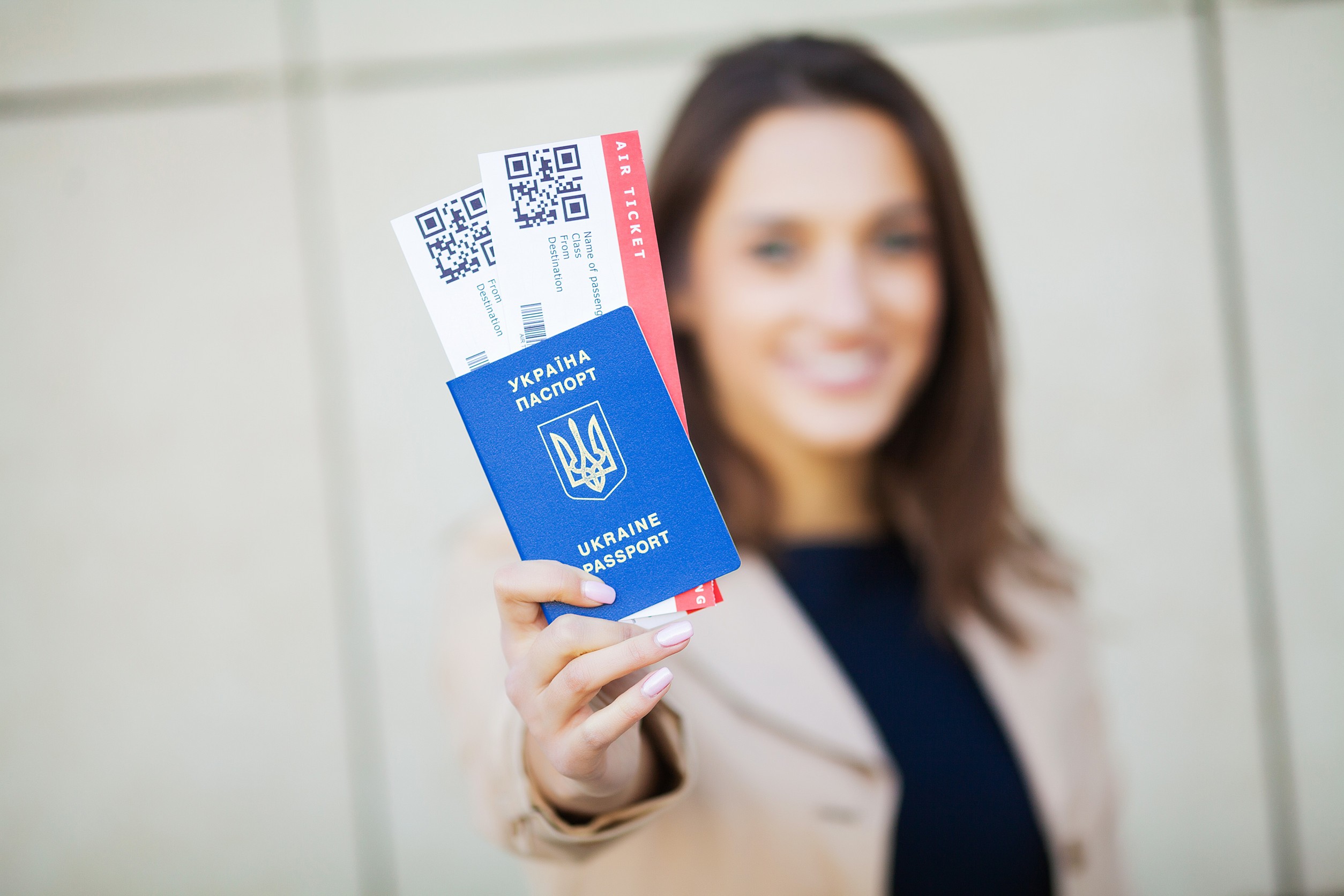 woman holding two air tickets in abroad passport near airport