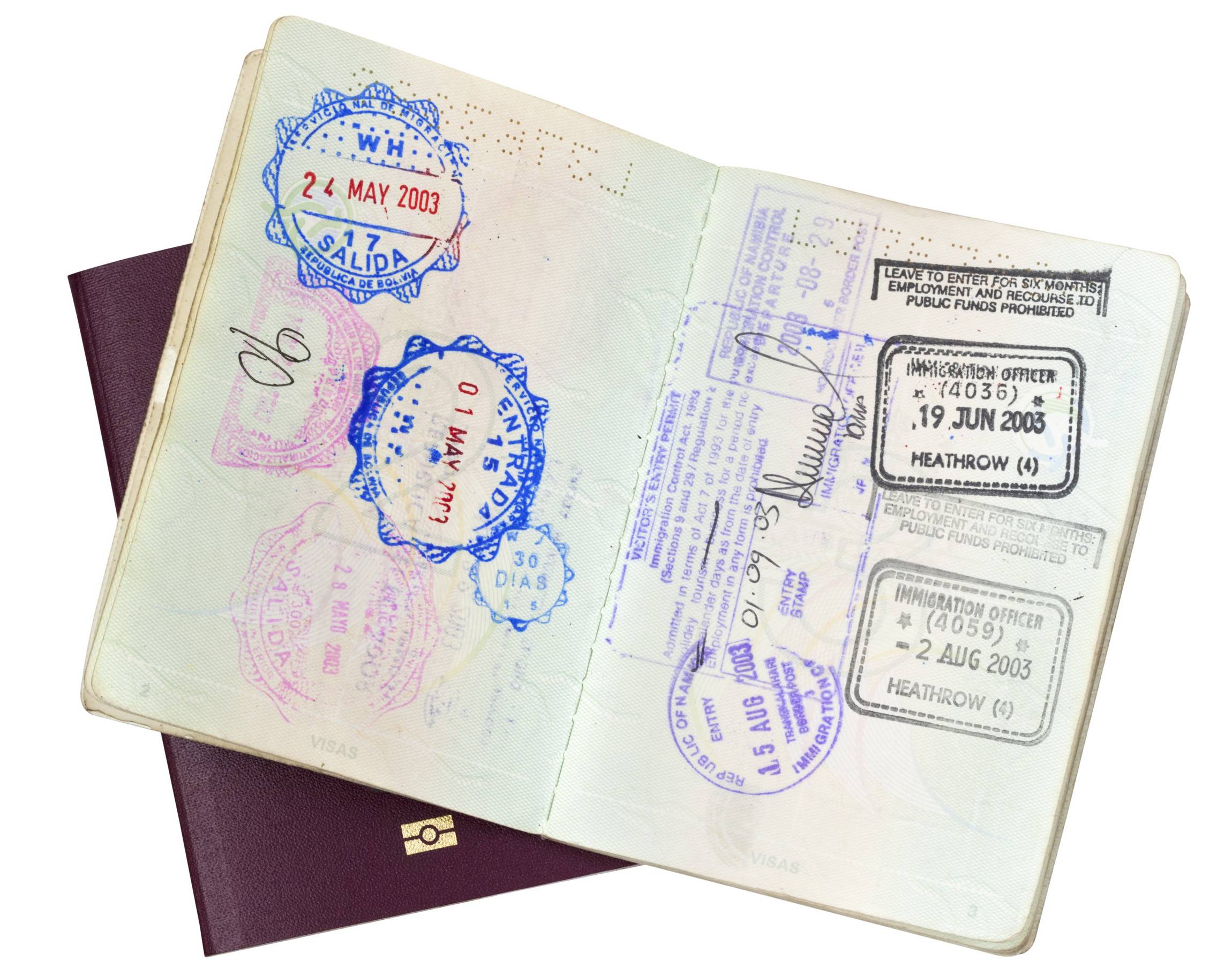 visa stamps in open passport over closed EU passport